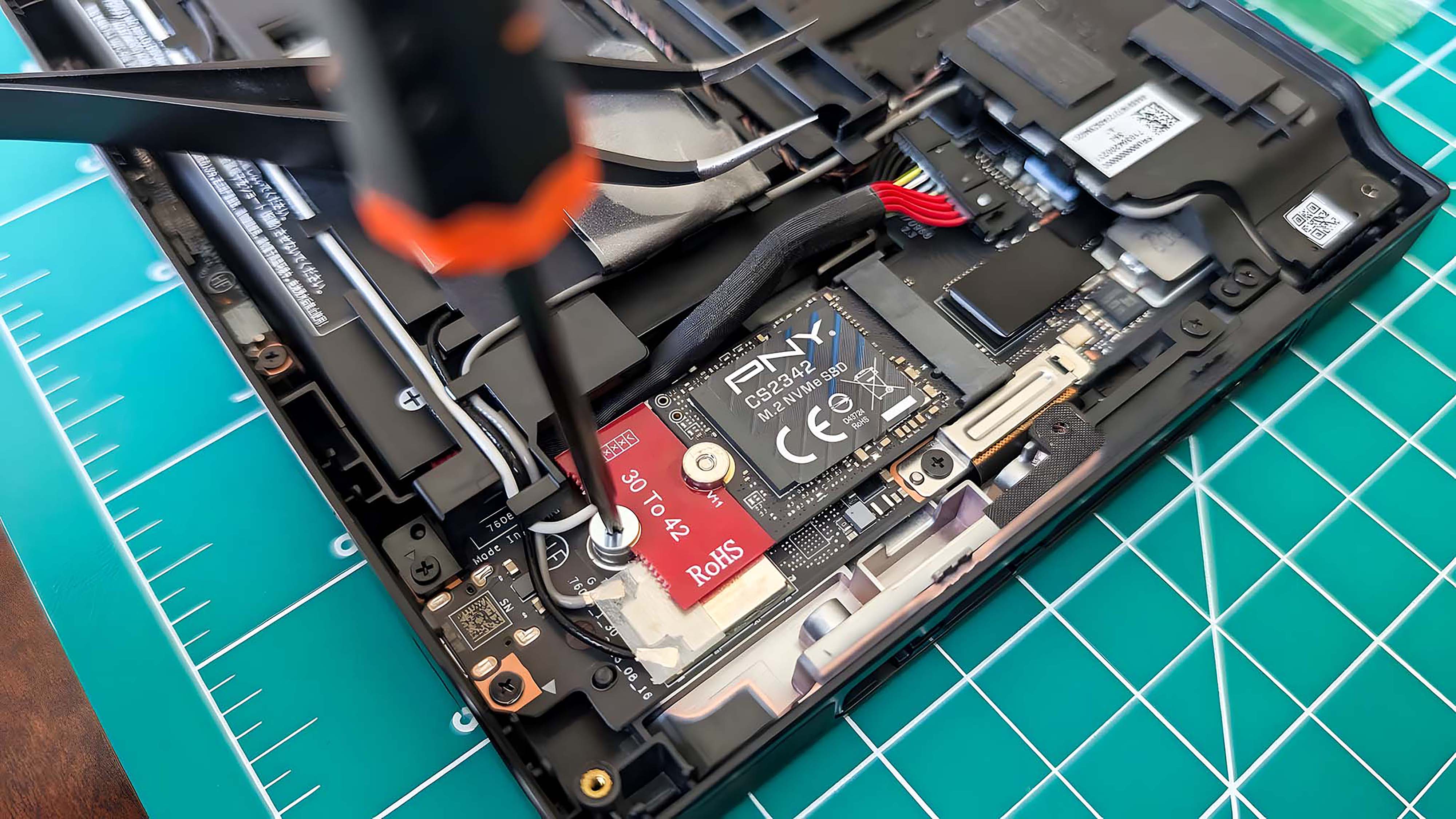 Отвертка закрепляет новый SSD Lenovo Legion Go на месте.