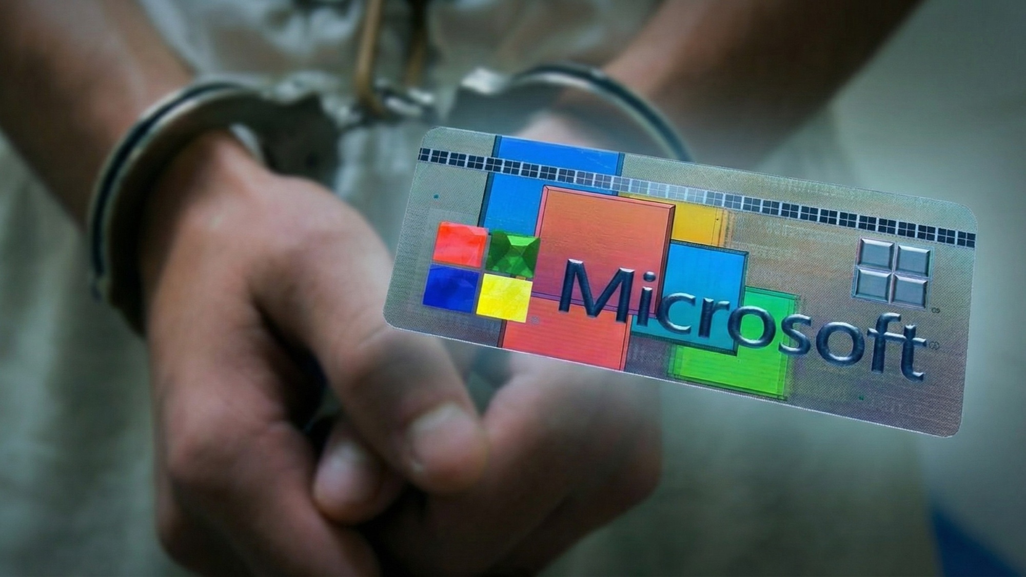 Руки в наручниках с ярлычком Microsoft Certificate of Authenticity (COA)