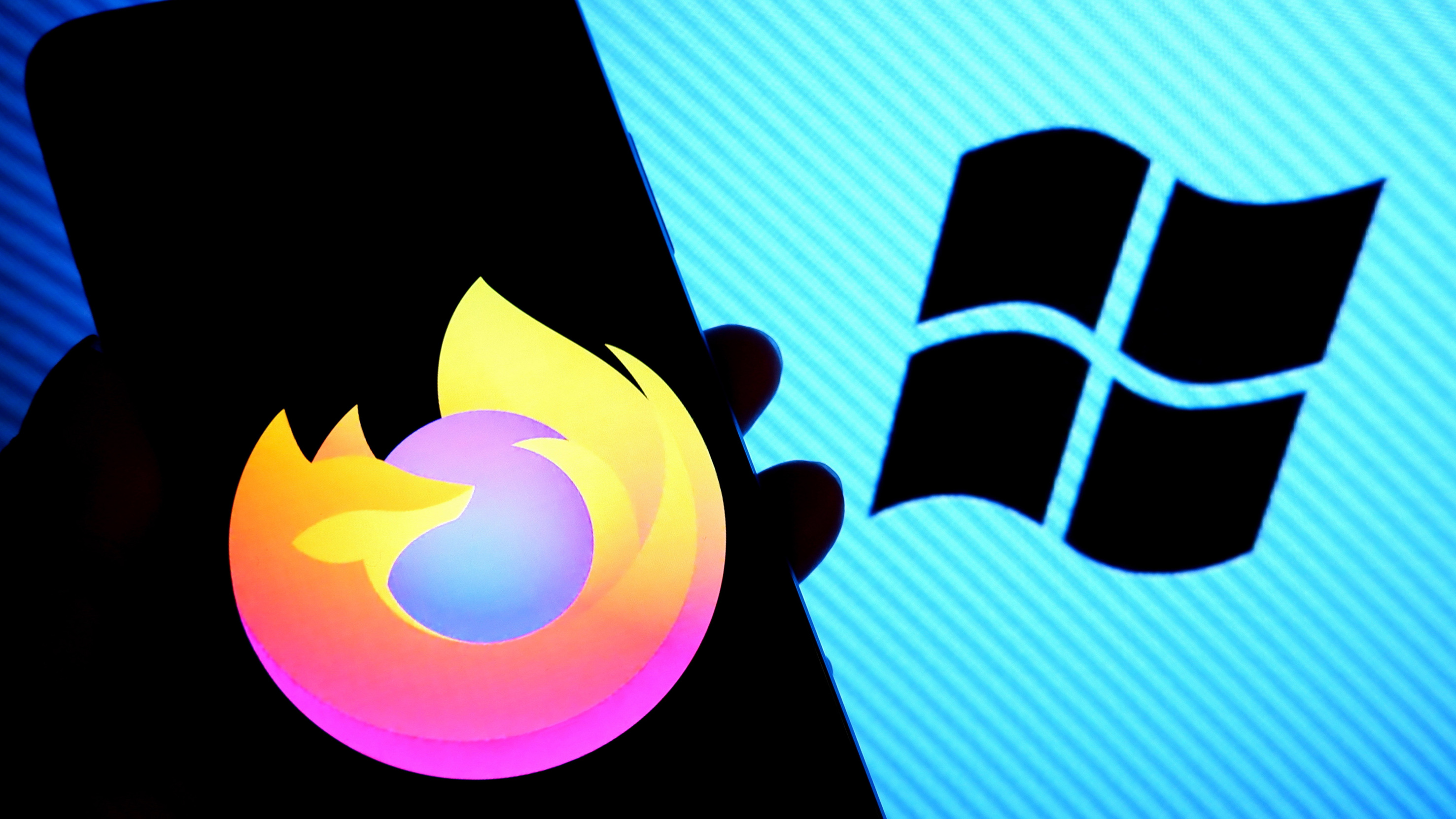 Firefox logo on a smartphone screen with Microsoft logo in background