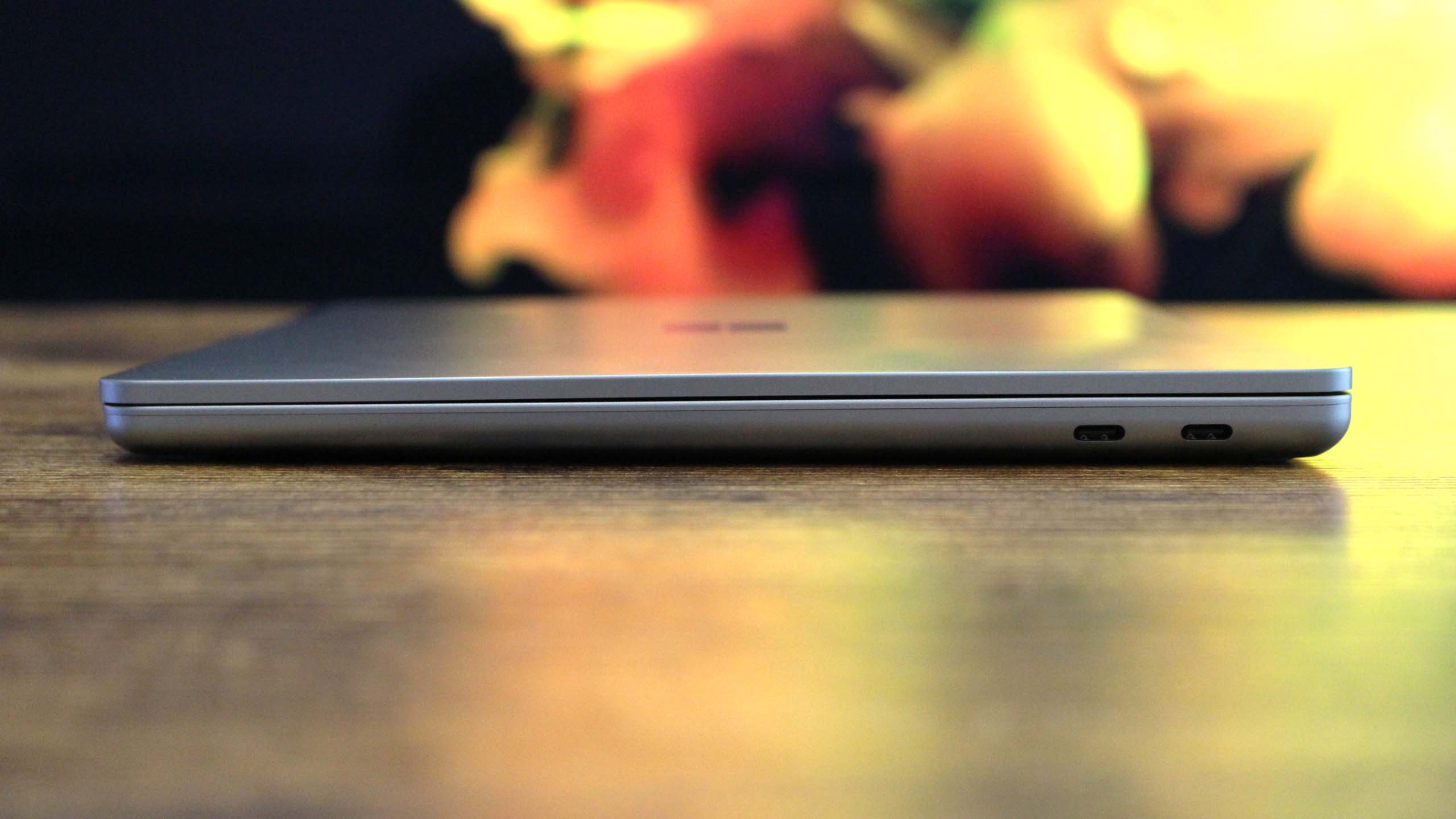 The Surface Laptop 13-inch, which offers superior battery life compared to the MacBook Neo, sitting closed on a desk.