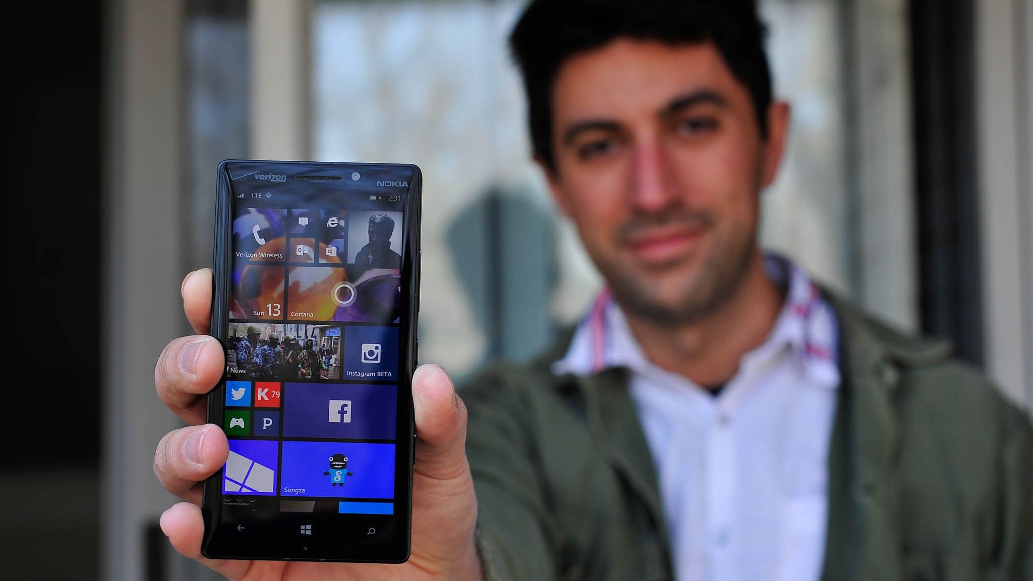A very fresh Windows Central Editor-in-Chief Daniel Rubino holding a Nokia phone running Windows Phone 8.1.